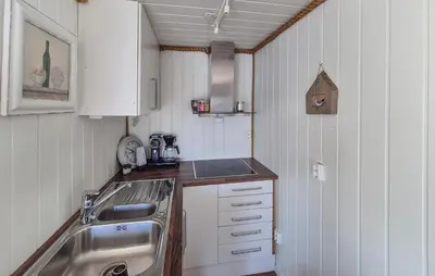 a small kitchen with a sink and a sink at Lovely Home In Mosterhamn With Sauna in Mosterhamn