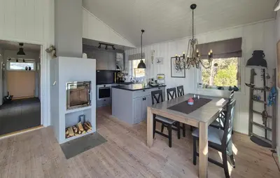 a kitchen and dining room with a table and chairs at Lovely Home In Mosterhamn With Sauna in Mosterhamn