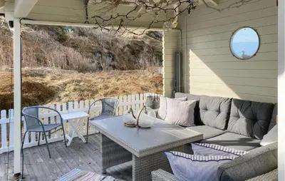 a patio with a couch and a table and chairs at Amazing Home In Averøy With Wifi in Averoy