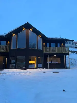 a large building with snow in front of it at Mountain View apartment in Isfjorden