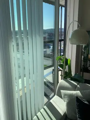 a living room with a couch and a large window at Bølgen Nyhavna in Trondheim