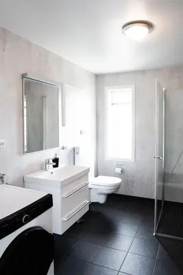 a white bathroom with a sink and a toilet at Komfortable Ferieleiligheter med Sjøutsikt in Stadlandet