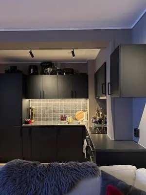 a kitchen with black cabinets and a black counter top at 3-room downtown apartment in Trondheim