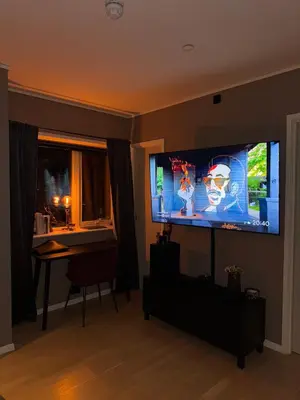 a living room with a large flat screen tv on the wall at 3-room downtown apartment in Trondheim