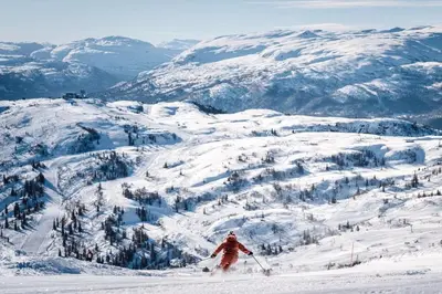 a person is skiing down a snow covered mountain at Apartment Tråstølen ski in ski out in Vossevangen