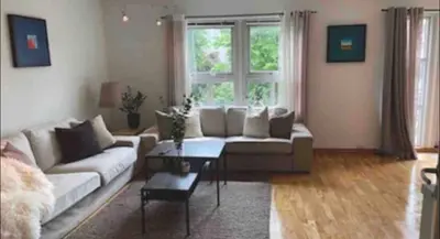 a living room with a couch and a table at Nice appartment in Bergens best location in Bergen