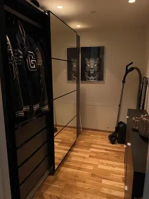 a room with a closet with a glass door at Centrally located apartment in Bergen
