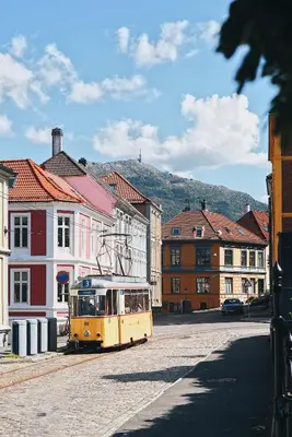 a yellow trolley car parked in a city street at DINBNB Apartments l Luxury Penthouse l Roof Terrace l Central Bergen in Bergen