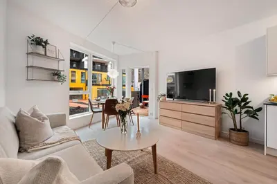 a living room with a couch and a table at Helt ny leilighet Ytre Sandviken in Bergen