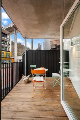 a room with a table and chairs on a balcony at Helt NY leilighet, Ytre Sandviken i Bergen in Bergen