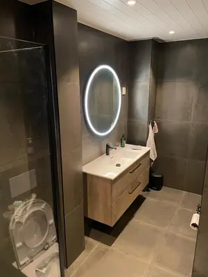 a bathroom with a sink and a mirror at Lars sitt hus in Lillehammer