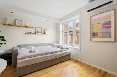 a bedroom with a bed and a window at Bergen Beds - Modern, Cozy & Perfect Location in Bergen