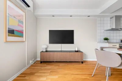 a living room with a flat screen tv on a wall at Bergen Beds - Modern, Cozy & Perfect Location in Bergen