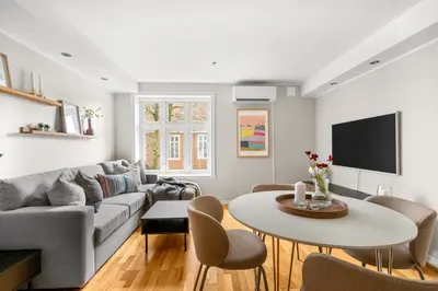 a living room with a couch and a table at Bergen Beds - Modern, Cozy & Perfect Location in Bergen