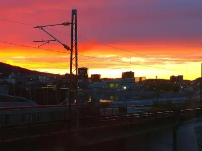 a sunset over a city with a train at Home is where your heart is! in Bergen