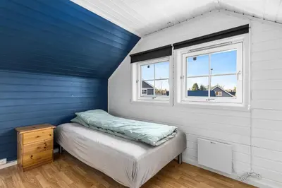 a small bedroom with a bed and a window at Hus i Verdal med 3 soverom in Verdal
