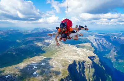 a man hanging from a rope on the top of a mountain at Large single-family home - Central in Voss in Vossevangen