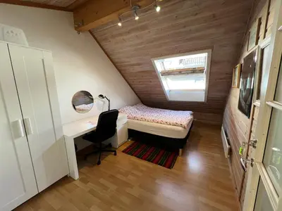 a small room with a desk and a bed and a window at Knirkenheimen in Trondheim