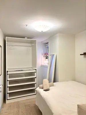 a bedroom with a bed and a walk in closet at Apartment behind Bryggen in Bergen in Bergen
