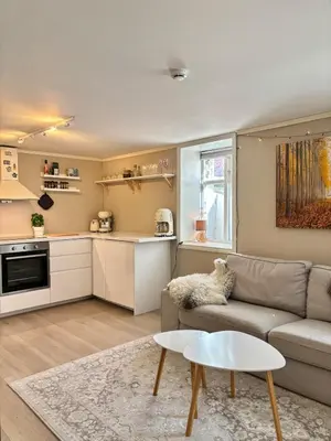 a living room with a couch and a table at Apartment behind Bryggen in Bergen in Bergen