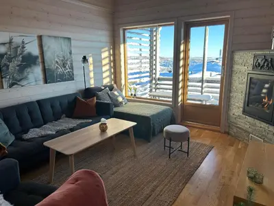 a living room with a couch and a table at Pellestova Apartments in Hafjell