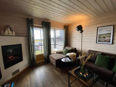 a living room with a couch and a fireplace at Pellestova Apartments in Hafjell