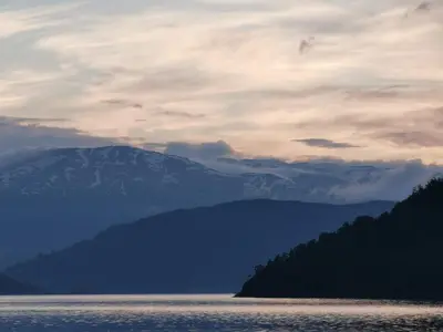 a large body of water with a mountain in the background at Kramsjø Gjestgiveri in Herand