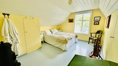 a bedroom with a bed and a window at Kramsjø Gjestgiveri in Herand