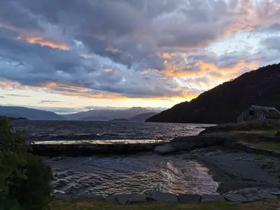 a view of a body of water at sunset at Kramsjø Gjestgiveri in Herand