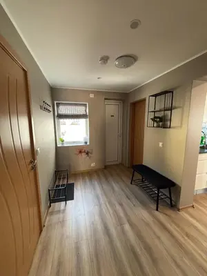 an empty living room with a bench and a window at Comfortable apartment in Ålesund in Ålesund