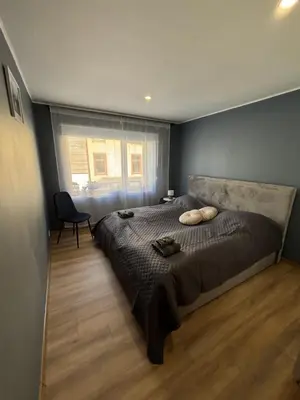 a bedroom with a large bed and a window at Comfortable apartment in Ålesund in Ålesund