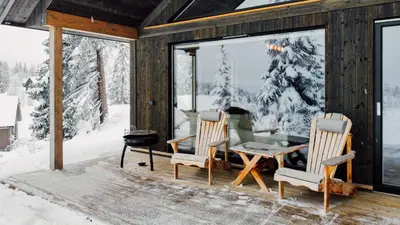 a cabin in the snow with a table and chairs at Modern Cabin With Mountain View By Syningtoppen in Torpo