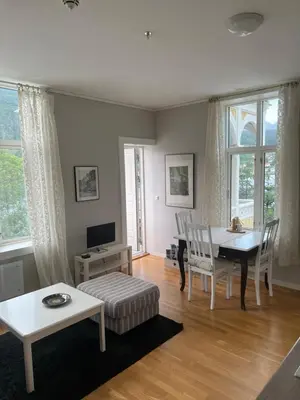a living room with a table and a dining room at Apartment in Stryn in Stryn