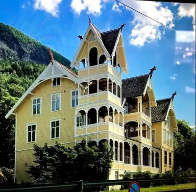 a large yellow building with a large turret at Apartment in Stryn in Stryn