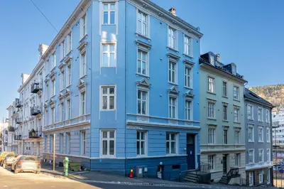 a blue building on the side of a street at Roomsly - Cozy Hilltop Hideout in Central Bergen in Bergen