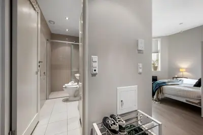 a bathroom with a bed and a toilet in a room at Roomsly - Cozy Hilltop Hideout in Central Bergen in Bergen