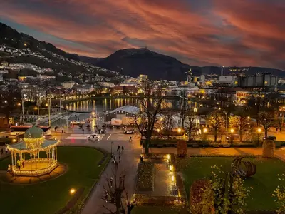 a view of a city at night with lights at Roomsly - Cozy Hilltop Hideout in Central Bergen in Bergen