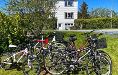 a group of bikes parked in front of a house at 3 Bedroom Cozy Apartment In Myklebost in Myklebost