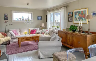 a living room with a couch and a table at 3 Bedroom Cozy Apartment In Myklebost in Myklebost