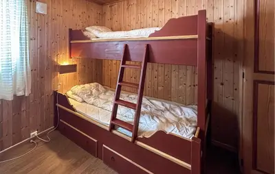 two bunk beds in a room with a ladder at Awesome Apartment In Rauland in Rauland
