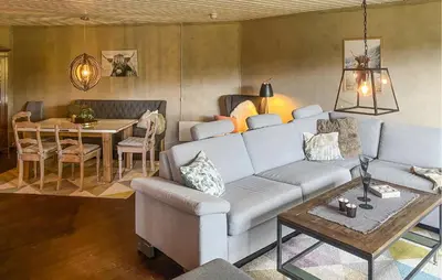 a living room with a couch and a table at Nice Apartment In Tisleidalen With Wifi in Tisleidalen