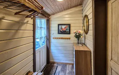 a hallway of a house with a table and flowers at Nice Home In Valen With House Sea View in Valen