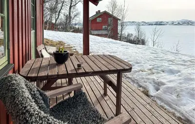 a wooden table on a porch in the snow at Nice Apartment In Rauland With Wifi in Rauland
