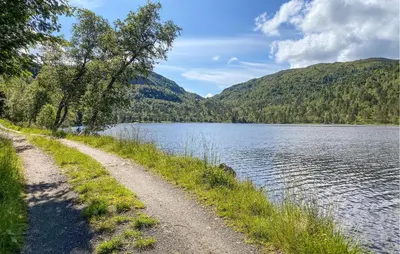 a dirt road next to a body of water at 1 Bedroom Gorgeous Apartment In Kvisvik in Kvisvik