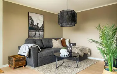 a living room with a gray couch and a table at 1 Bedroom Gorgeous Apartment In Kvisvik in Kvisvik