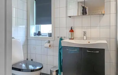 a bathroom with a sink and a toilet at Lovely Apartment In Myklebost With Wifi in Myklebost