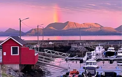a rainbow in the sky over a marina with boats at Lovely Apartment In Myklebost With Wifi in Myklebost