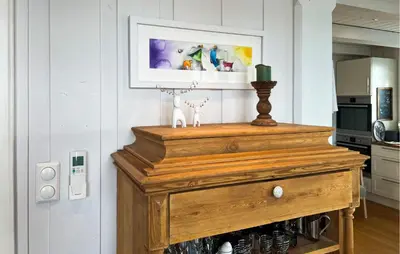 a wooden cabinet in a kitchen with a picture on the wall at Lovely Home In Aurdal With Sauna in Aurdal