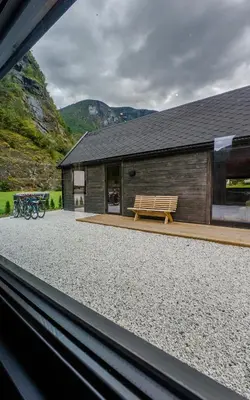a building with a bench in front of it at Flåm Minisuite in Aurland
