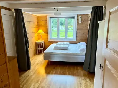 a small bedroom with a bed and a window at Hylen in Kvilldal